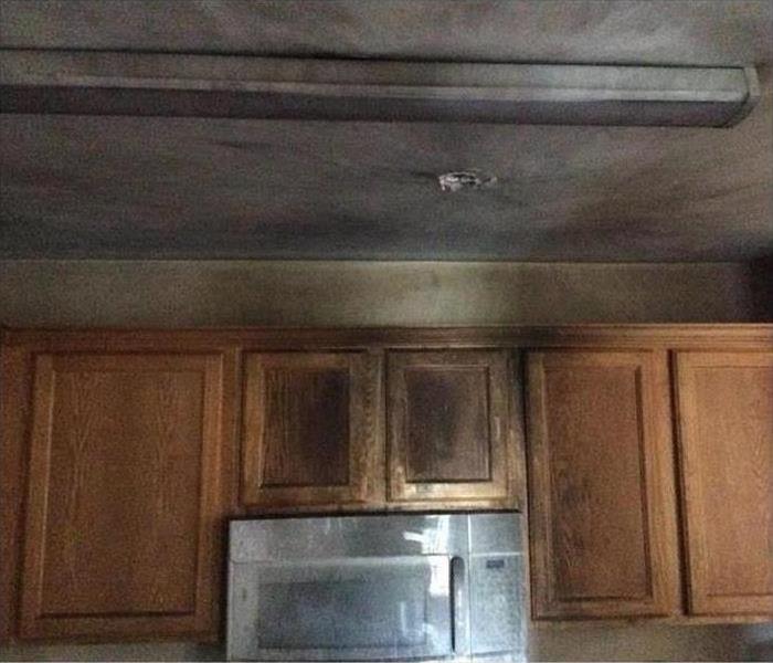 Cabinets of a home covered with smoke