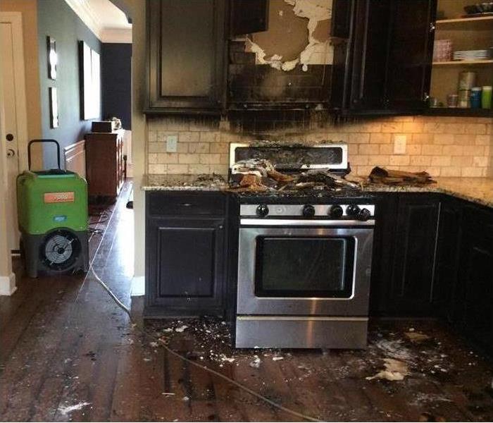 burned stove and kitchen cabinets